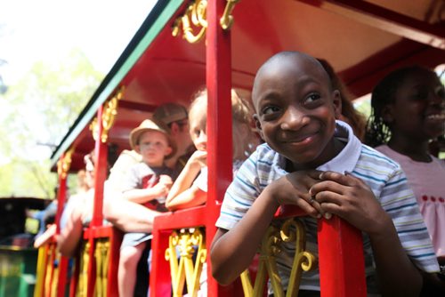 Nine year old Isaac Adegunju (sister Esther beside him on his left) is all smiles as he rides the  Assiniboine Park Steam Train Tuesday afternoon as it celebrates itÄôs 50th birthday.   The train was purchased in Pennsylvania and did it's first run in the park on July 29th, 1964, and it hasnÄôt stopped running since.  Free hotdogs and cake were offered to riders throughout the afternoon.  Standup photo  July 29, 2014 Ruth Bonneville / Winnipeg Free Press
