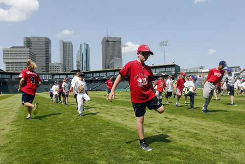 Stdup- Fun and Run . Wpg Goldeyes talk baseball skills to kids  at  the  McDonald's Alstar Skills Camp put on for kids at Shaw Park Tuesday afternoon in conjuction with the all star being  game tonight at the park . Goldeyes players coached baseball skills  to the kids at various stations . July 29 2014 / KEN GIGLIOTTI / WINNIPEG FREE PRESS