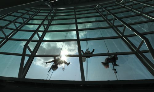 High Rise window washers with Picture Perfect Window Cleaning wash the windows on the Canadian Museum for Human Rights Tuesday afternoon all in preparation for the grand opening which is less than 2 months away.   See Murray McNeil's story.  Names from left - Kyle Dufort, John Burridge (centre) and Chris Tonn (right).  July 29, 2014 Ruth Bonneville / Winnipeg Free Press