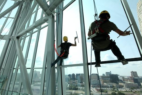 High Rise window washers with Picture Perfect Window Cleaning wash the windows in the Hope Tower in the Canadian Museum for Human Rights Tuesday afternoon all in preparation for the grand opening which is less than 2 months away.   See Murray McNeil's story.  Names - Silas Chipelski (left) and Robyn Hendrickson.  July 29, 2014 Ruth Bonneville / Winnipeg Free Press