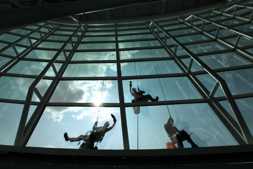 High Rise window washers with Picture Perfect Window Cleaning wash the windows on the Canadian Museum for Human Rights Tuesday afternoon all in preparation for the grand opening which is less than 2 months away.   See Murray McNeil's story.  Names from left - Kyle Dufort, John Burridge (centre) and Chris Tonn (right).  July 29, 2014 Ruth Bonneville / Winnipeg Free Press