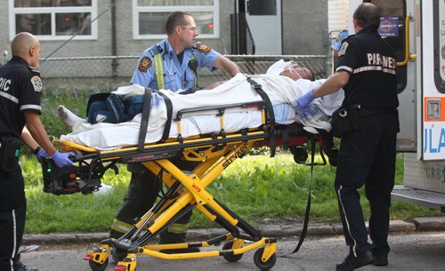 A Winnipeg Fire  Department First Responders and EMS rush a man to hospital in a stabbing incident at 293 Alfred Ave Wednesday Breaking News- July 30, 2014   (JOE BRYKSA / WINNIPEG FREE PRESS)
