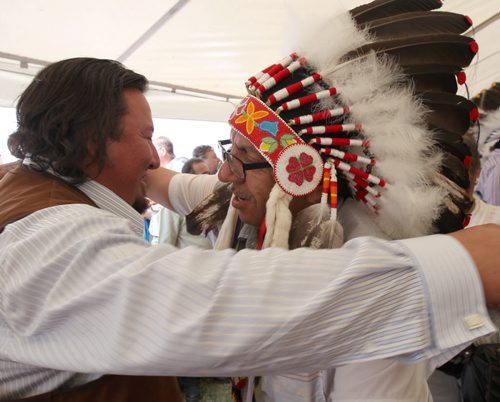 Derek Nepinak, left, is congratulated by a long line of Manitoba chiefs after being re-voted as the Grand Chief for the Assemble of Manitoba Chiefs See Alex Paul Story- July 30, 2014   (JOE BRYKSA / WINNIPEG FREE PRESS)