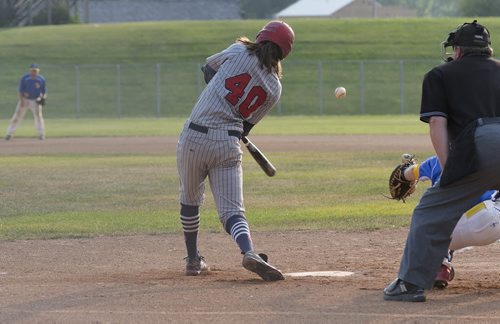 Elmwood Giant Matt Smith misses the ball during the first inning of their game against St. Boniface Legionaires at Whittier Park on Wednesday evening. Sarah Taylor / Winnipeg Free Press July 30, 2014