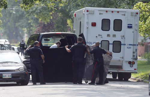 Wpg Police use black cloth  to shield  body on gurney to remove a body from the Stella Ave  house,they  continue to investigate a house in the 500 Block of Stella Ave after an all night standoff . The Standoff ended around 3:40 am after 17 hours. July 31 2014 / KEN GIGLIOTTI / WINNIPEG FREE PRESS