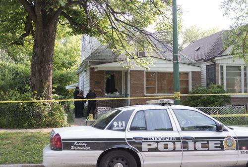 Winnipeg Police investigate the house at 512 Stella Ave after an all night standoff. The 17-hour standoff ended around 3:40 am. Sarah Taylor / Winnipeg Free Press July 31, 2014