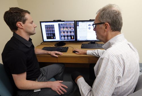 LIFE front . LtoR  Researcher doctors  ,LtoR  Dr. Michael  Ellis and  Dr. DR. Mutch  (right ) studying data  from MRI .  Doctors research  in order to diagnose concusions at HSC Kleysen Institute using MRI and  blood flow .story by Shamona  Aug 1 2014 / KEN GIGLIOTTI / WINNIPEG FREE PRESS
