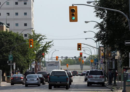 York St. times lights , can be confusing and dangerous if yu are watching the wrong lights . Traffic light and road safety  story by Mary Agnes Welch  Aug 1 2014 / KEN GIGLIOTTI / WINNIPEG FREE PRESS