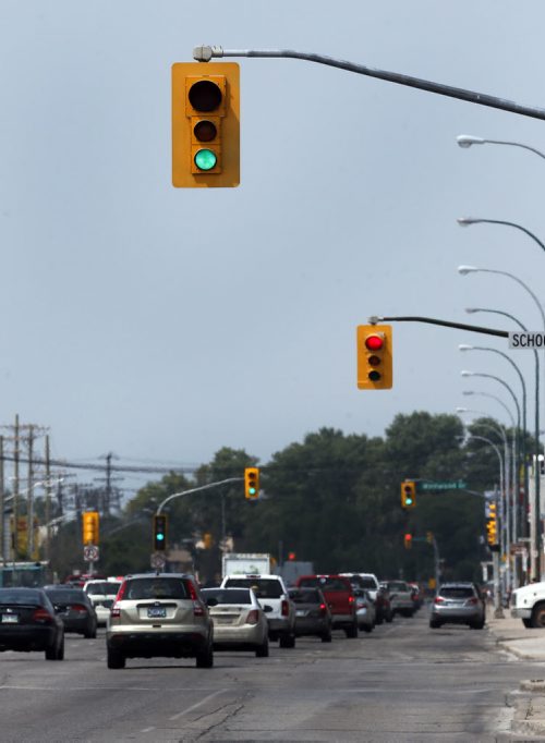 Dangerous Timed lights on Portage Ave near School road sometimes they appear out of sequence or a driver is watching the wrong set when they are close together .Traffic light and road safety  story by Mary Agnes Welch  Aug 1 2014 / KEN GIGLIOTTI / WINNIPEG FREE PRESS