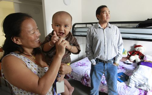 Laxman Bhujel with wife Sukhamina Rai and son Ryan (one of their two children) in their small  apartment in Welcome Place in Winnipeg. Carol Sanders story. Wayne Glowacki/Winnipeg Free Press August 1 2014