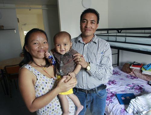 Laxman Bhujel with wife Sukhamina Rai and son Ryan (one of their two children) in their small  apartment in Welcome Place in Winnipeg. Carol Sanders story. Wayne Glowacki/Winnipeg Free Press August 1 2014