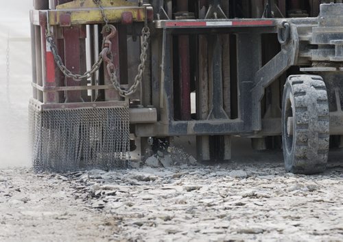 Construction teams use a rubblizer to smash up the old pavement and becomes a layer of gravel as they work on Highway 75 south of St. Norbert. Sarah Taylor / Winnipeg Free Press - Dan Letts story