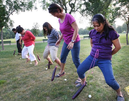 Summer Fun-Mendoza Family going away party at Kilnonan Park Friday night- Susan Cabaguio, right, and her friends and family have a laugh playing a game of egg plant relay Standup Photo- Aug 01, 2014   (JOE BRYKSA / WINNIPEG FREE PRESS)