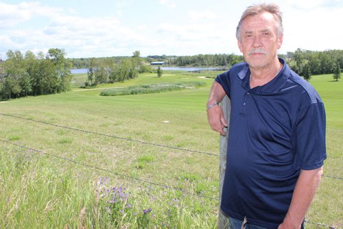 014 - Larry Kotyk overlooking the golf course he claims is flooding his land near Onanole.  BILL REDEKOP/WINNIPEG FREE PRESS July 31,2014