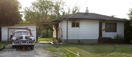 The house at 639 Muriel St. with a for sale sign in front appears to have damage from a fire Monday night. Wayne Glowacki/Winnipeg Free Press Aug. 5 2014