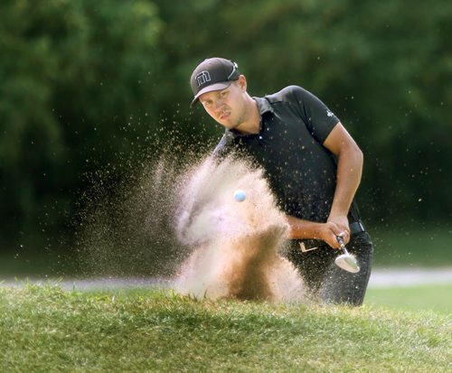 Trouble Brewing-Manitoba leader Josh Wytnick of Glenboro, shoots 4 from a sand trap which he went on to double put for a triple bogey on the 11 th par three hole at The 110th Canadian Mens Amateur Golf Tournament at Elmhurst Golf and Country Club See Tim Campbell story- Aug 05, 2014   (JOE BRYKSA / WINNIPEG FREE PRESS)