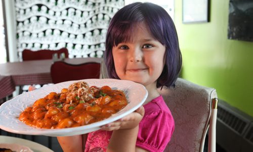 Restaurant Review - Little Maria's  Four year old Maria Boss smiles as she holds a plate of homemade Gnocchi that her father makes at his deli (named after her) on Edmonton. Owner did not want his picture taken.  Asked only that his daughter's picture be taken along with plates of food.  Aug 02, 2014 Ruth Bonneville / Winnipeg Free Press