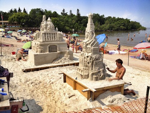 Kyle Pohl, right front, creates a sand castle on the beach at Grand Beach. He stared it last Wednesday and the peices of art will take about 100 hours to make. They were created for display at this weekends family sand castle competition.  BORIS MINKEVICH/WINNIPEG FREE PRESS  August 5, 2014