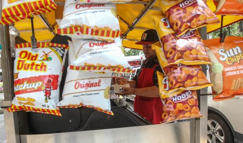 Sonny Richard prepares a smoky at Billy's BBQ cart as crowds gather during the noon hour for lunch on Broadway Tuesday. for photo weekend photo page. 140805 - Tuesday, August 05, 2014 -  (MIKE DEAL / WINNIPEG FREE PRESS)