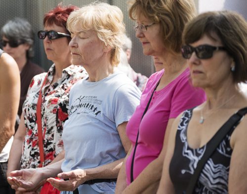 Sue Ostapowich gathered with multi-faith and human right groups for a circle of silent contemplation at the Forks Gandhi statue on Tuesday afternoon. Ostapowich says she likes to come to things like this that resonate with her, she believes in a higher power and that we are all one. Sarah Taylor / Winnipeg Free Press August 5, 2014