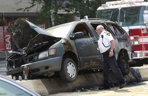 A van ended up on the median on Portage Ave. near Carlton St. and burst into flames Tuesday afternoon. The the driver escaped from the van and wasn't injured. Wayne Glowacki/Winnipeg Free Press August 5 2014