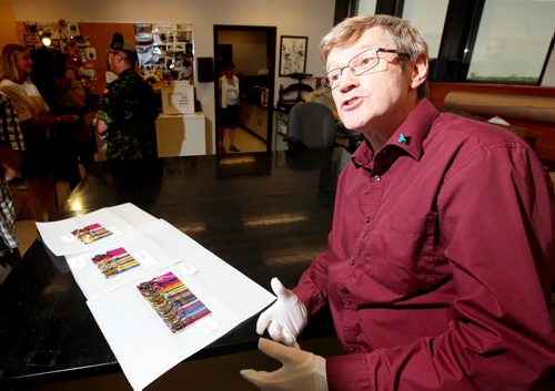 Tony Glen, Director of Research and Collection at the Canadian War Museum unveils the three "Valor Road" medal sets including Victoria crosses to be displayed starting Wednesday at the Manitoba Museum. See release/story. August 5, 2014 - (Phil Hossack / Winnipeg Free Press) VALOUR ROAD VICTORIA CROSS MEDALS HAVE ARRIVED¤ IN WINNIPEG¤¤ Monday, August 4, 2014 ¤ WINNIPEG,Manitoba:¤The original Victoria Cross medals awarded almost 100 years ago to three Winnipeg soldiers who served in the First World War are now in Winnipeg¤and will be¤turned over to The Manitoba Museum by officials of the Canadian War Museum¤at a special ceremony¤this Wednesday, August 6. ¤ The public is¤welcome to attend the Opening Ceremonies for the¤ the Valour Road¤Victoria¤Cross Medal¤display that will get underway at¤1:30 P.M.¤in the Alloway Hall of The¤Manitoba¤Museum. ¤ The Victoria Crosses of Valour Road¤medals were awarded to Lieutenant Robert Shankland, Sergeant-Major Frederick William Hall, and Corporal Leo Clarke in the First World War. In that war, all three, in separate actions, distinguished themselves by their extreme bravery in fighting the enemy. ¤ At the time of their enlistment,¤the three had all resided in the same block of Pine Street in the west end of Winnipeg.¤In honour of the accomplishments of these¤Pine Street¤soldiers, a phenomena that was unique to¤Canada,¤Pine Street¤was renamed¤Valour Road¤in the 1920s.¤ ¤ The Victoria Crosses of Valour Road¤medals will be on public display at The Manitoba Museum until they are returned to their permanent home at the¤Canadian¤War¤Museum¤in¤Ottawa¤at the end of Remembrance Week, the 14th of November 2014. ¤ The project¤to bring The Victoria Crosses of Valour Road Exhibit to Winnipeg is a collaborative effort of The Royal Military Institute of Manitoba (RMIM),The Manitoba Museum and the Canadian War Museum and is¤supported by a grant from the Winnipeg Foundation.¤ ¤ ¤ --30 ¤ NOTE TO EDITORS: Media representatives will be allowed access t