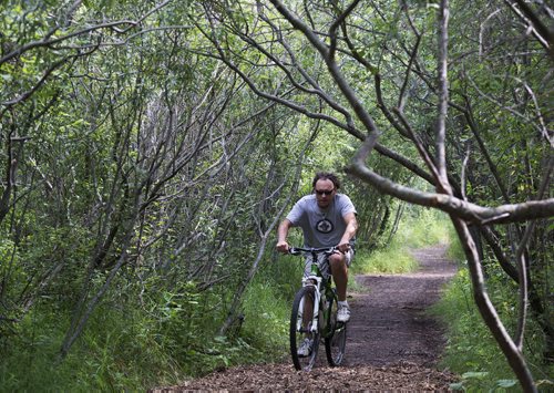 Jonathan Richards has come through Assiniboine Forest everyday for the past 10 years. He used to walk his dog here until she passed away and has since been riding his bike. Sarah Taylor / Winnipeg Free Press August 6, 2014