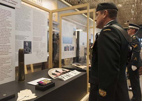 Master warrant officer Wayne Nicholson and David Badger present the Victoria Cross Medals to their display at the Manitoba Museum on Wednesday afternoon. Sarah Taylor / Winnipeg Free Press August 6, 2014