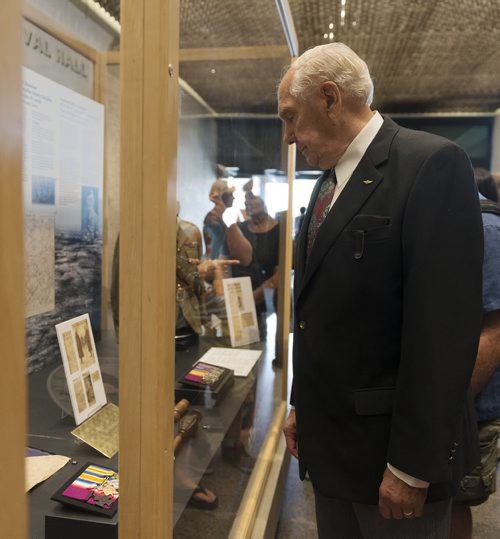 Leo Clarke looks at his uncle Corporal Clarke's display at the Manitoba Museum on Wednesday. Clarke, remembers cleaning the medal all the time as they were in his family up until five years ago. Sarah Taylor / Winnipeg Free Press August 6, 2014