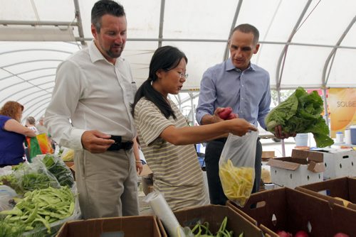 LOCAL - St. Norbert Farmers Market gets a boost from the government to improve their facilities at the popular market. Dave Gaudreau, NDP-St. Norbert, market farmer Ming Zhai, and NDP Kevin Chief pose for some photos in the market . BORIS MINKEVICH / WINNIPEG FREE PRESS  August 6, 2014