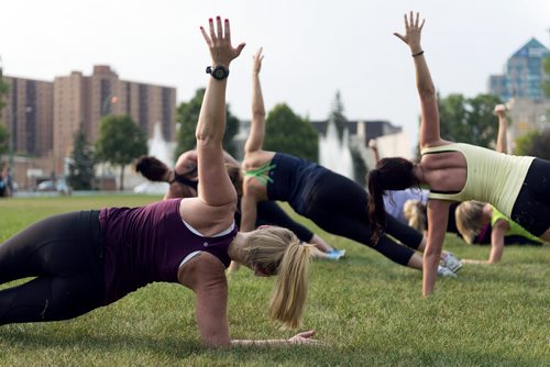 Lululemon store manager Robyn Penner (left) leads the run-ur-asanaoff workout at Memorial park on Wednesday evening, which will continue every Wednesday night for the remainder of August. Sarah Taylor / Winnipeg Free Press August 6, 2014