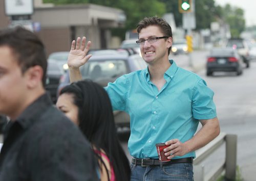 Matt Allard who is running for city councillor of St. Boniface in the up coming civic election was out with about 65 supporters Thursday morning waving to commuters on Rue Archibald. see release.  Wayne Glowacki/Winnipeg Free Press August 7 2014