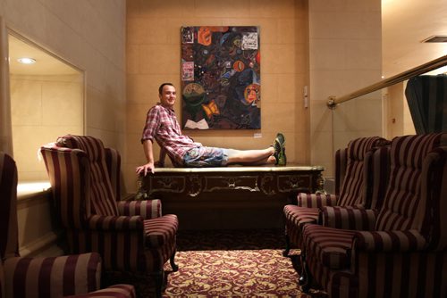 Fort Garry Hotel becoming an art hotel. About 45 pieces have been hung around the lobby, mezzanine, restaurants, Palm Lounge and lower floor- The exhibit is called Art at the Fort Garry- Here artist Craig Love sits next to his piece "Browning: Optimist" See Kevin Prokosh story- Aug 06, 2014   (JOE BRYKSA / WINNIPEG FREE PRESS)