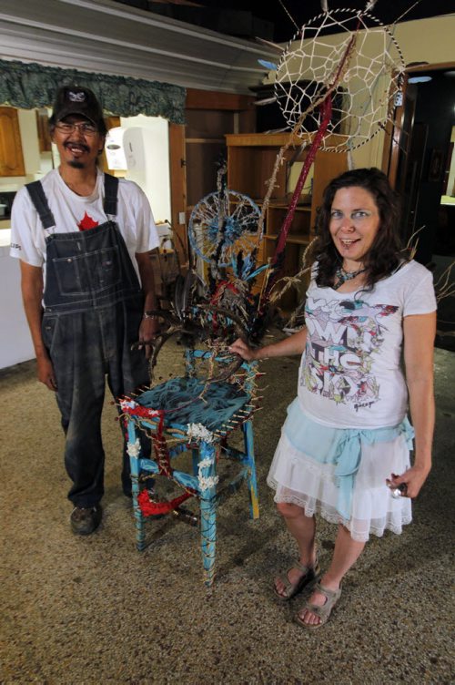 LOCAL - Brian Ironstand and Ashli Roberts pose next to the first chair they sanded and transformed into art. Red Road Lodge is working on street beautification projects thanks to the funding theyve received from the Downtown BIZs sleepout. Theyre working on a project where they repurpose chairs right now and will place them around  town. The working tagline for the project right now is Dont sit down, stand up for homelessness. BORIS MINKEVICH / WINNIPEG FREE PRESS  August 7, 2014