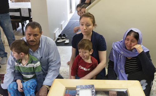 Nafia Naso (middle) sits with her son Lavan Hassan, mother Koulan Fandi (far right), father Ehez Jallo and her older son Maher Hassan to talk about their family and friends in Iraq who have gone missing. Sarah Taylor / Winnipeg Free Press August 7, 2014