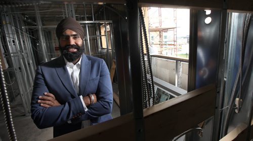KARAMPAUL SANDHU, owner of Sandhu Developments Inc., which is converting this 6-storey former manufacturing plant (311 Alexander Ave., at Stanley) into an 88-unit apartment block. The project, which involves a complete redevelopment of the interior of the building is  about 50 per cent complete. See story and other photos. See Murray McNeil story. August 8, 2014 - (Phil Hossack / Winnipeg Free Press)
