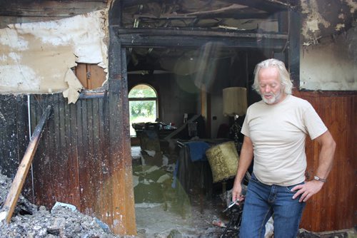 Doug Bergman and the Beausejour landmark he was 90 per cent finished restoring before it burned down July 20. The house is a complete loss. BILL REDEKOP/WINNIPEG FREE PRESS Aug 7,2014