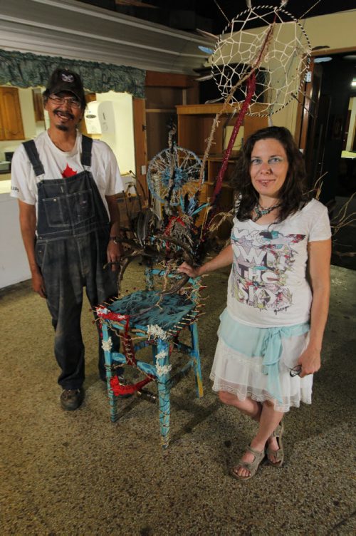 LOCAL - Brian Ironstand and Ashli Roberts pose next to the first chair they sanded and transformed into art. Red Road Lodge is working on street beautification projects thanks to the funding theyve received from the Downtown BIZs sleepout. Theyre working on a project where they repurpose chairs right now and will place them around  town. The working tagline for the project right now is Dont sit down, stand up for homelessness. BORIS MINKEVICH / WINNIPEG FREE PRESS  August 7, 2014