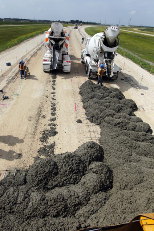 ROAD PROJECT - Cement being poured near on highway 75 south of Winnipeg Near St. Agathe, MB. Dan Lett epic. BORIS MINKEVICH / WINNIPEG FREE PRESS  August 7, 2014