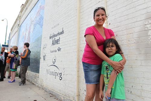 Althea Guiboche, also known as the Bannock Lady, stands near the corner where she hands out free bannock  weekly (Dufferin & Main) with her children after talking to the media about her views on the recent Facebook posting scandal.  WIth her son Justin (6yrs). See story.   Aug 09, 2014 Ruth Bonneville / Winnipeg Free Press
