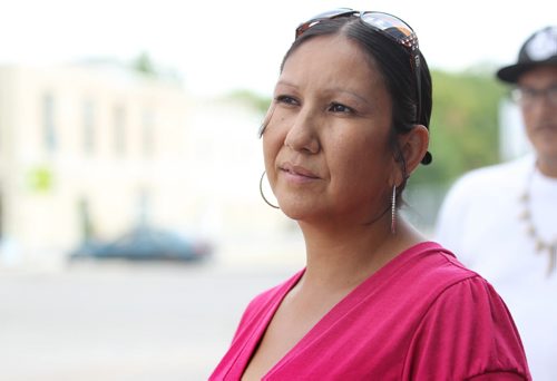 Althea Guiboche, also known as the Bannock Lady, stands near the corner where she hands out free bannock  weekly (Dufferin & Main) with her children after talking to the media about her views on the recent Facebook posting scandal.   See story.   Aug 09, 2014 Ruth Bonneville / Winnipeg Free Press