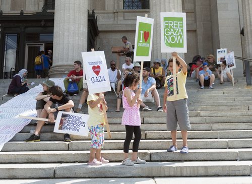 Eileen Kashalo, 5, Menal Kashalo, 7, and Bashir Kashalo, 9 attend the Gaza rally on Saturday at the Legislative Building. They have come to all of the four rallies Winnipeg has held for Gaza in the past three weeks. Sarah Taylor / Winnipeg Free Press August 9, 2014