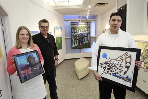 From left, artist Kait Evinger holding a print of her painting "Bison", Nigel Bart, Studio Facilitator and founder and artist Bradley Guibouche with his painting titled "Forever Strong in the   Upbeat Artworks, a new pop-up gallery in Portage Place. The artwork at Upbeat is created exclusively by people with mental health issues. Jessica Botelho-Urbanski story Wayne Glowacki/Winnipeg Free Press August 11 2014