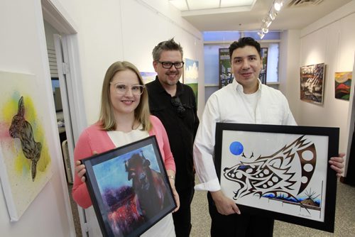 From left, artist Kait Evinger holding a print of her painting "Bison", Nigel Bart, Studio Facilitator and founder and artist Bradley Guibouche with his painting titled "Forever Strong in the Upbeat Artworks, a new pop-up gallery in Portage Place. The artwork at Upbeat is created exclusively by people with mental health issues. Jessica Botelho-Urbanski story Wayne Glowacki/Winnipeg Free Press August 11 2014