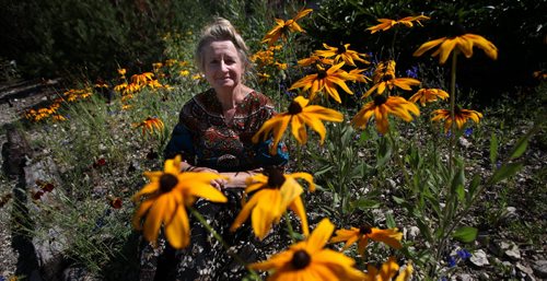 U of Winnipeg's Toxicologist Dr Eva Pip, poses with wildflowers, at home near Beausejour. This indomitable environmentalist-some would say polarizing crusader, raises her own food and even her own honey. She's got the simple life down pat. See Alex Paul's GreenPage feature. August 11, 2014 - (Phil Hossack / Winnipeg Free Press)