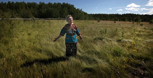 U of Winnipeg's Toxicologist Dr Eva Pip, embraces a meadow she reclaimed from plowed sterility, at home near Beausejour. This indomitable environmentalist-some would say polarizing crusader, raises her own food and even her own honey. She's got the simple life down pat. See Alex Paul's GreenPage feature. August 11, 2014 - (Phil Hossack / Winnipeg Free Press)