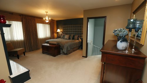 mastre bedroom with fireplace , and  with second spiral staircase to main floor spa room , Homes ,luxury home in  La Salle Mb. At 50 Kingswood Drive  story by Todd Lewys . Aug 12 2014 / KEN GIGLIOTTI / WINNIPEG FREE PRESS