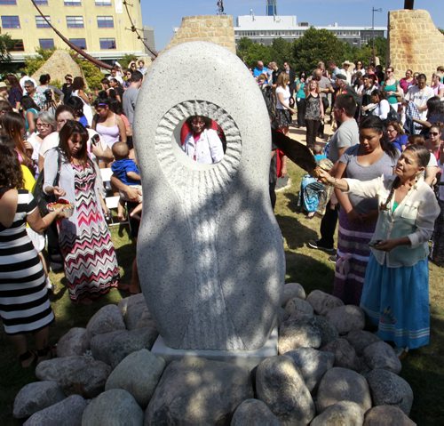 About 150 people including family of missing and murdered indigenous women and girls attended the monument unveiling ceremony by the Oodena Circle at The Forks Tuesday.Leslie Spillett, executive director at Ka Ni Kanichihk at right by the white granite monument.  see web story  Wayne Glowacki/Winnipeg Free Press August 12 2014
