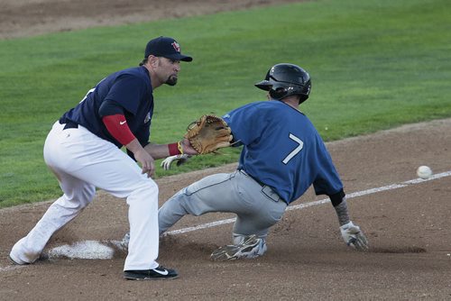 August 12, 2014 - 140812  -   Winnipeg Goldeyes' Jake Blackwood (11) can't get St. Paul Saints' Joey Becker (7) out at third in Winnipeg, Tuesday, August 12, 2014.  John Woods / Winnipeg Free Press