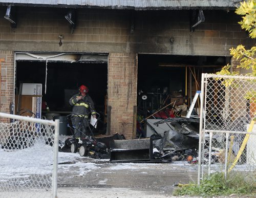 Wpg Fire fighters were kept busy at a fire in the rear loading dock area of Sccope International  at 1466 Arlington St at Magnus Ave .Thhe fire is out  and traffic is moving on Arlington Ave although fire crews are still on scene mopping up.  Aug 14 2014 / KEN GIGLIOTTI / WINNIPEG FREE PRESS